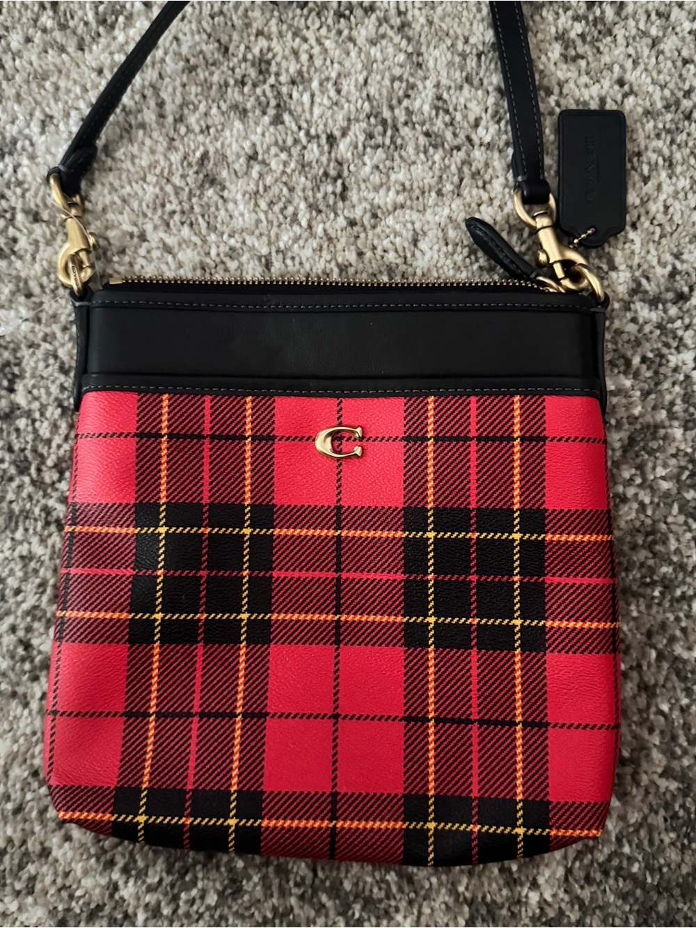 Coach Kitt Messenger Crossbody bag featuring striking red and black plaid.
